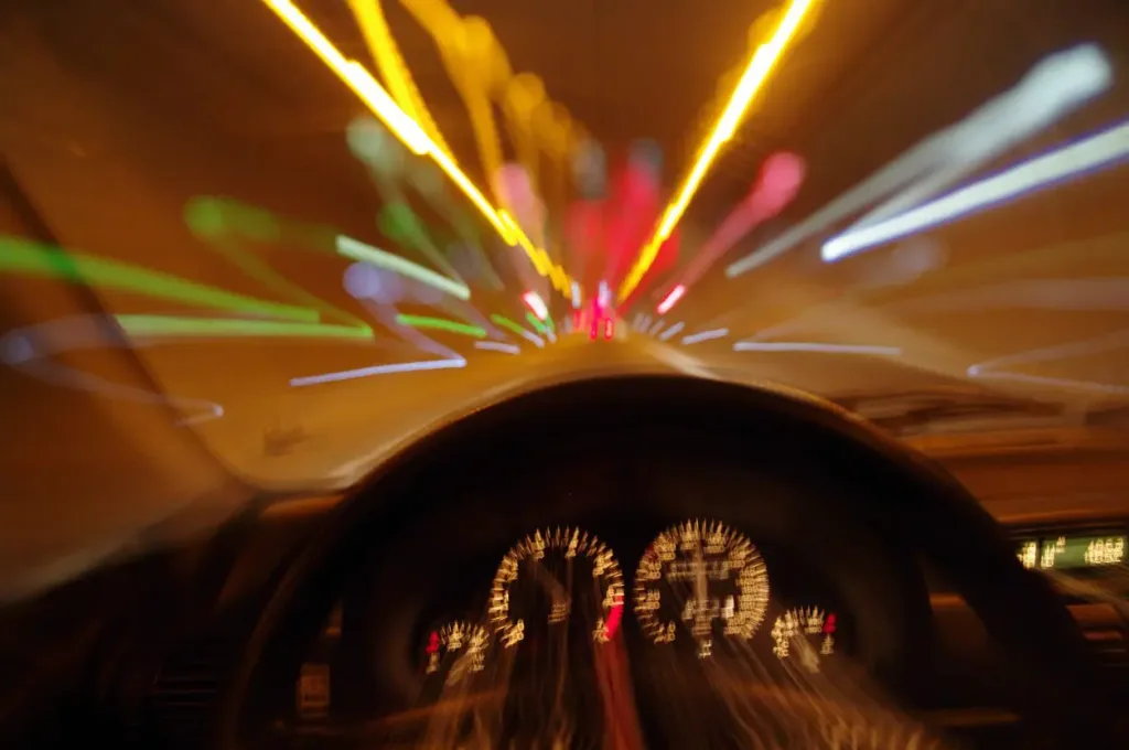 Blurry perspective of someone driving a car. Our Houston drunk driving accident lawyers defend those who've been hurt by drunk drivers.