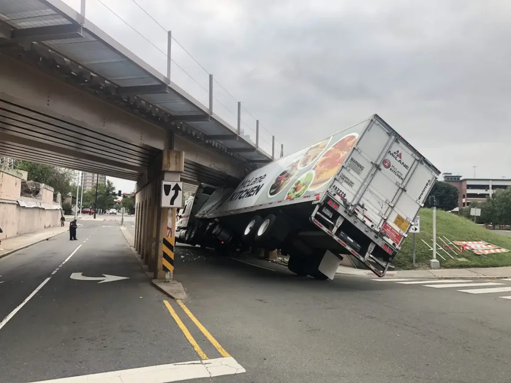 Commercial truck stuck under an overpass. Our Houston personal injury lawyers hold truck drivers accountable for negligence. 