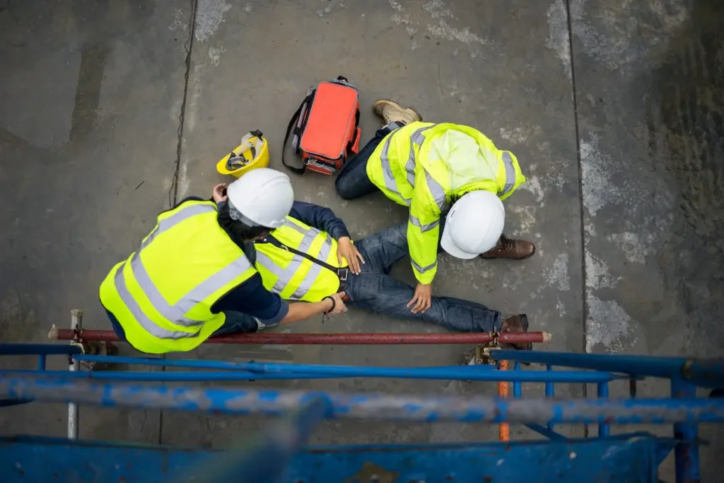Team members helping employee who was injured at work. If you've sustained injuries at work, contact a Houston work injury lawyer now.