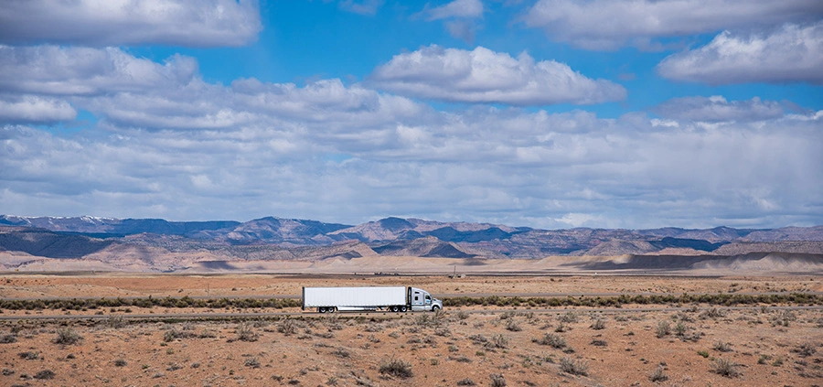 Semi truck driving through the desert