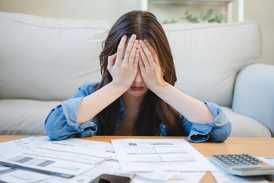 Woman stressed over money and bills