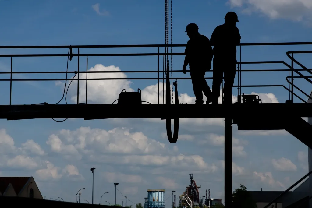 Construction workers on a platform.