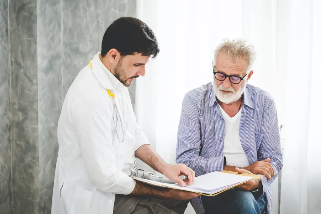 Elderly man speaking with a doctor.